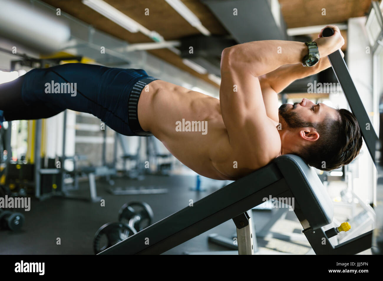 Young handsome man doing exercise for abdominal muscles Stock Photo