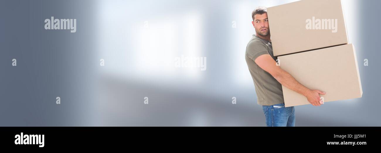 Man carrying boxes in front of blurred copy space background Stock Photo