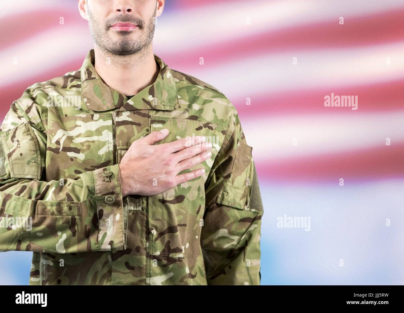 Part of a soldier with hand on the heart against fluttering american flag Stock Photo