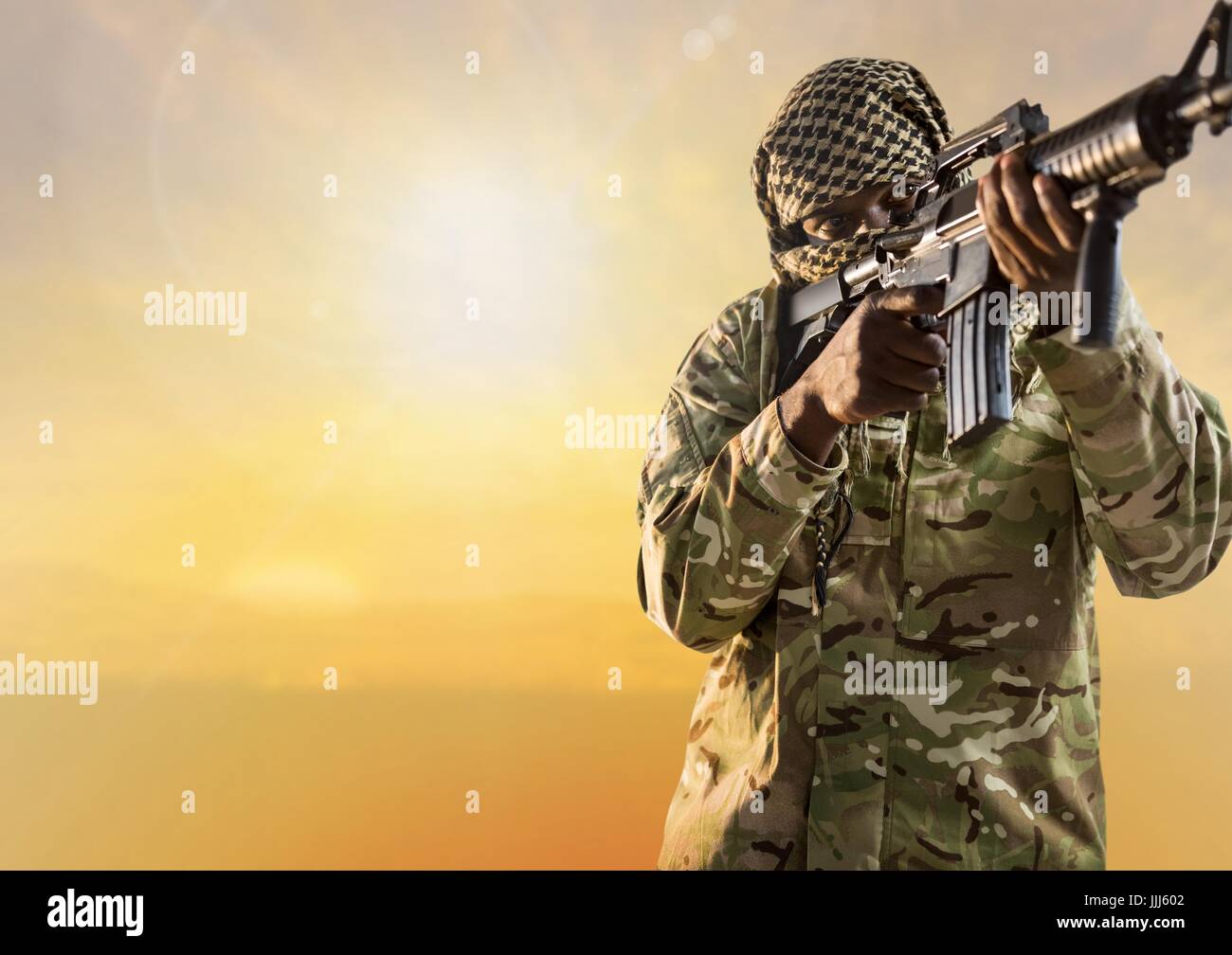 Black soldier holding a firearm in desert Stock Photo