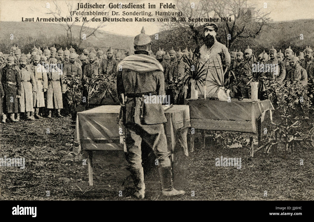 Jewish soldiers praying at religious service while on active duty with Field rabbi Dr Sonderling from Hamburg in World War I, Dated 29-20 September 1914 - probably Jewish New Year . Soldier wears prayer shawl. Soldiers wearing typical Prussian  helmuts. Reads; Judischer Gottesdienst im Felde Stock Photo