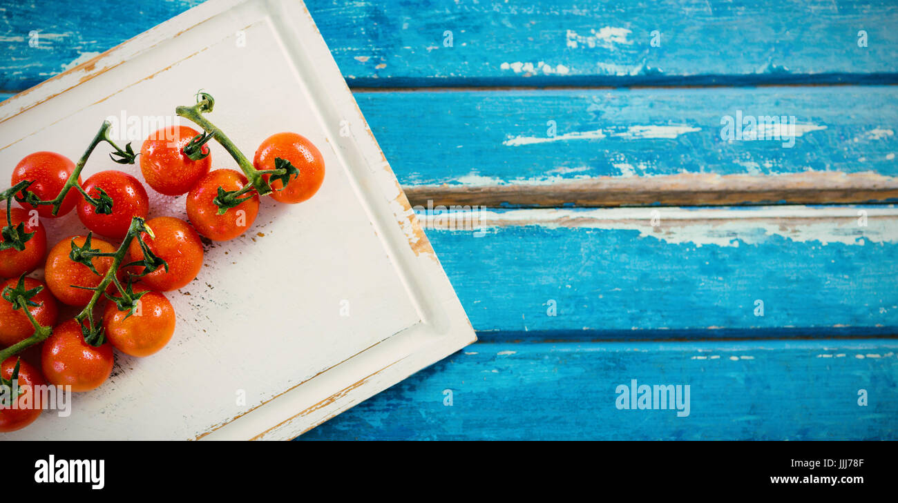 Cherry tomatoes on white cutting board Stock Photo - Alamy