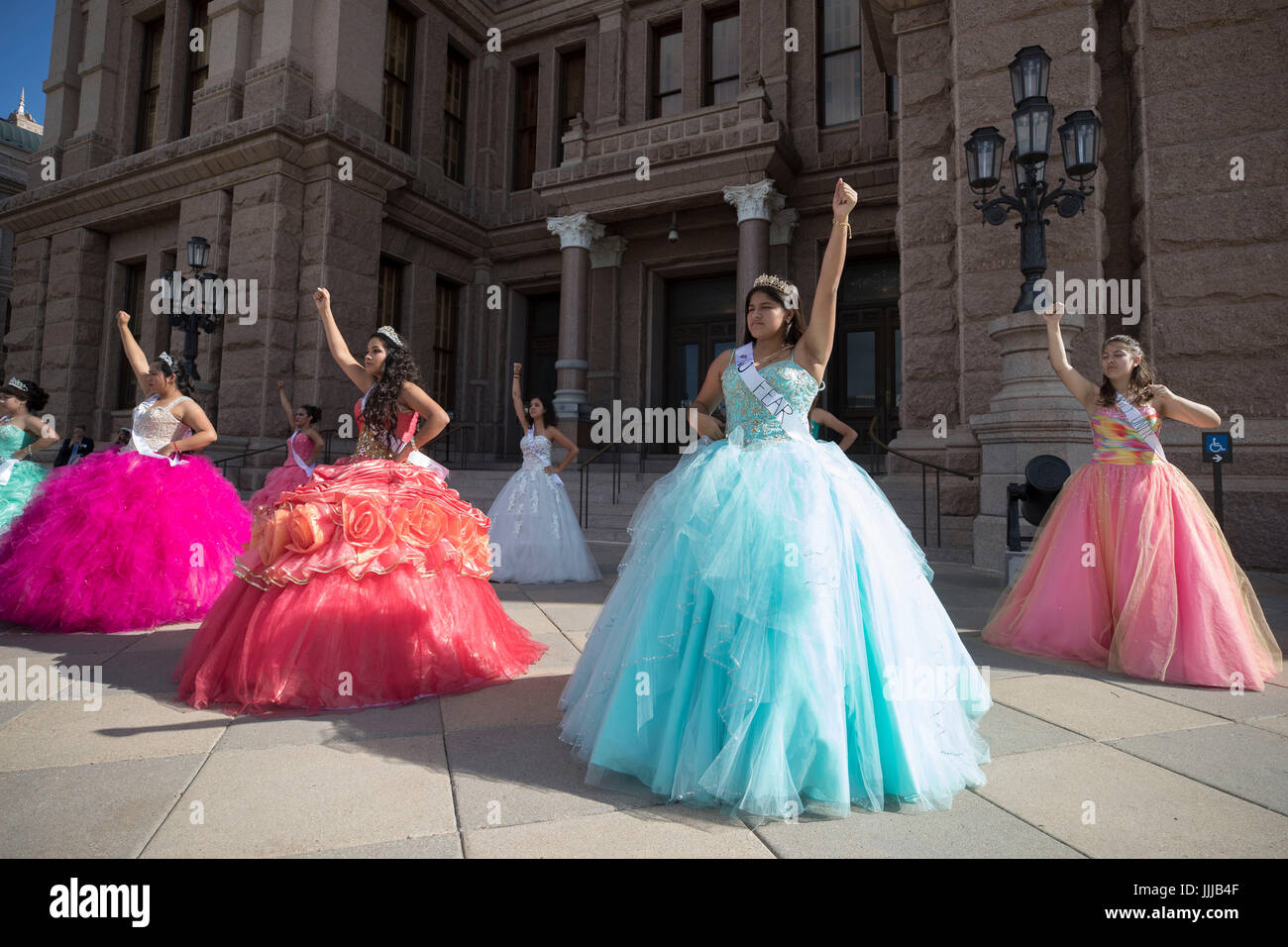 Teen girls wearing Mexican-style quinceanera dresses at the Texas Capitol protest SB4, passed by the legislature and signed by the governor in Spring 2017, a'Show me your papers' bill authorizing police to ask people to prove their immigration status at any time. Stock Photo