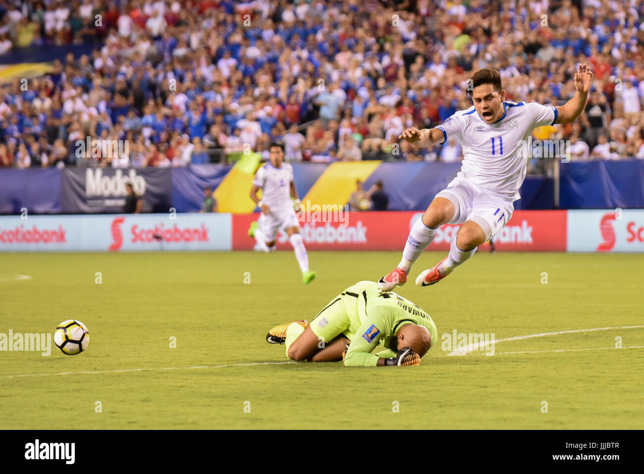Tim Howard goalkeeper of the USMNT United States Mens National Team makes an incredible goalie save on Rodolfo Zelaya and nearly avoids a collision during a soccer | football match against El Salvador as part of the CONCACAF Gold Cup Stock Photo