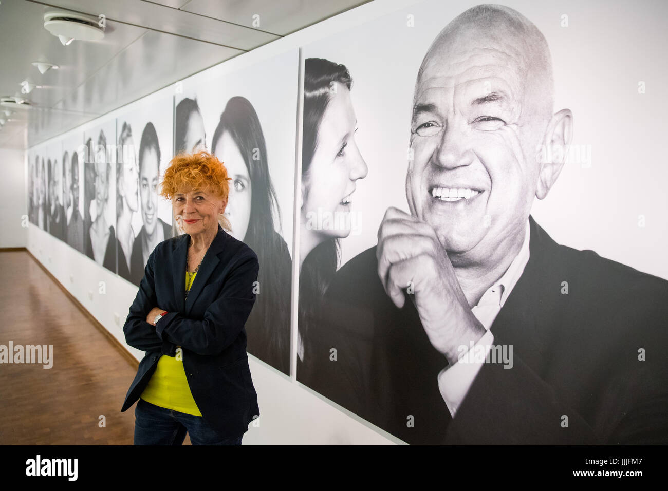Photographer Herlinde Koelbl standing in front of her exhibits in the exhibition 'Stille Post (lit. Silent Post, name of the children's game known as, among others, Chinese whispers). Hearing and understanding' in the Museum for Communication in Nuremberg, Germany, 20 July 2017. The project by the photographer from Munich consists of black-and-white pictures of men, women and children from 16 countries from all five continents and shows them as 28 different couples whispering to each other a message which remains hidden from the viewer. The exhibition will be open until 10 September 2017. Phot Stock Photo