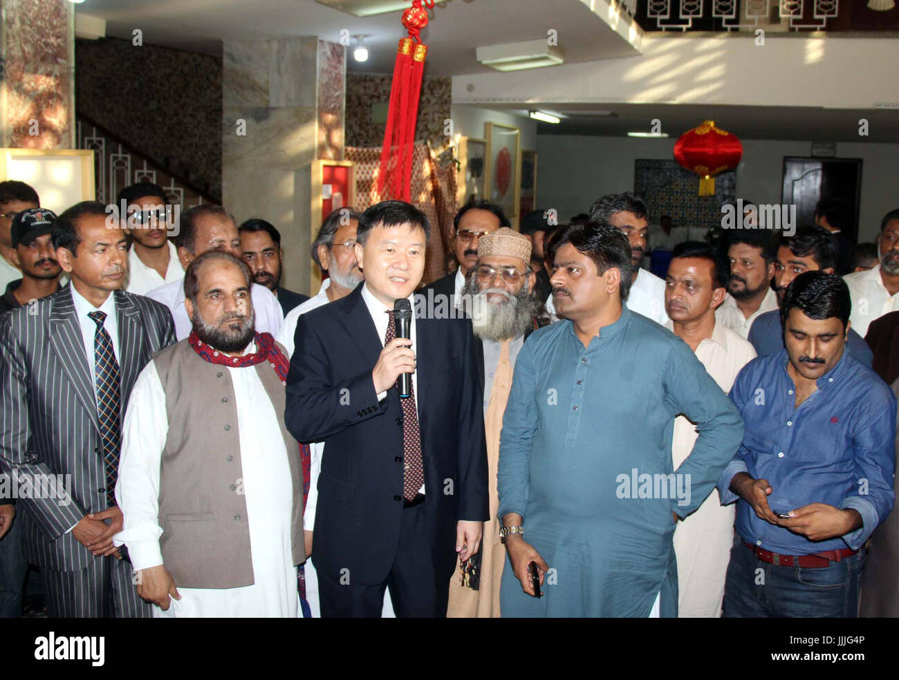 Consul General of People's Republic of China H.E. Mr. Wang Yu accompanied by Vice Consul General Mr. Mu Yongpeng and Sindh Minister of Culture Sardar Shah talking to media persons and attendees of Chinese Paper Cutting Art Exhibition held at National Museum of Karachi on Thursday, July 20, 2017. Stock Photo