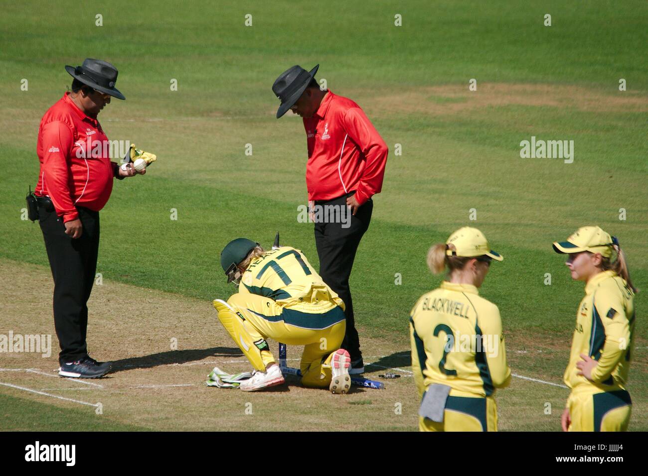 Derby, UK. 20th July, 2017. Umpires Shaun George and Ahsan Raza watch as Australia wicketkeeper Alyssa Healy attempts to repair the hole for the middle stumop during their match against India in the ICC Women's World Cup semi final at the County Ground Derby. Credit: Colin Edwards/Alamy Live News Stock Photo