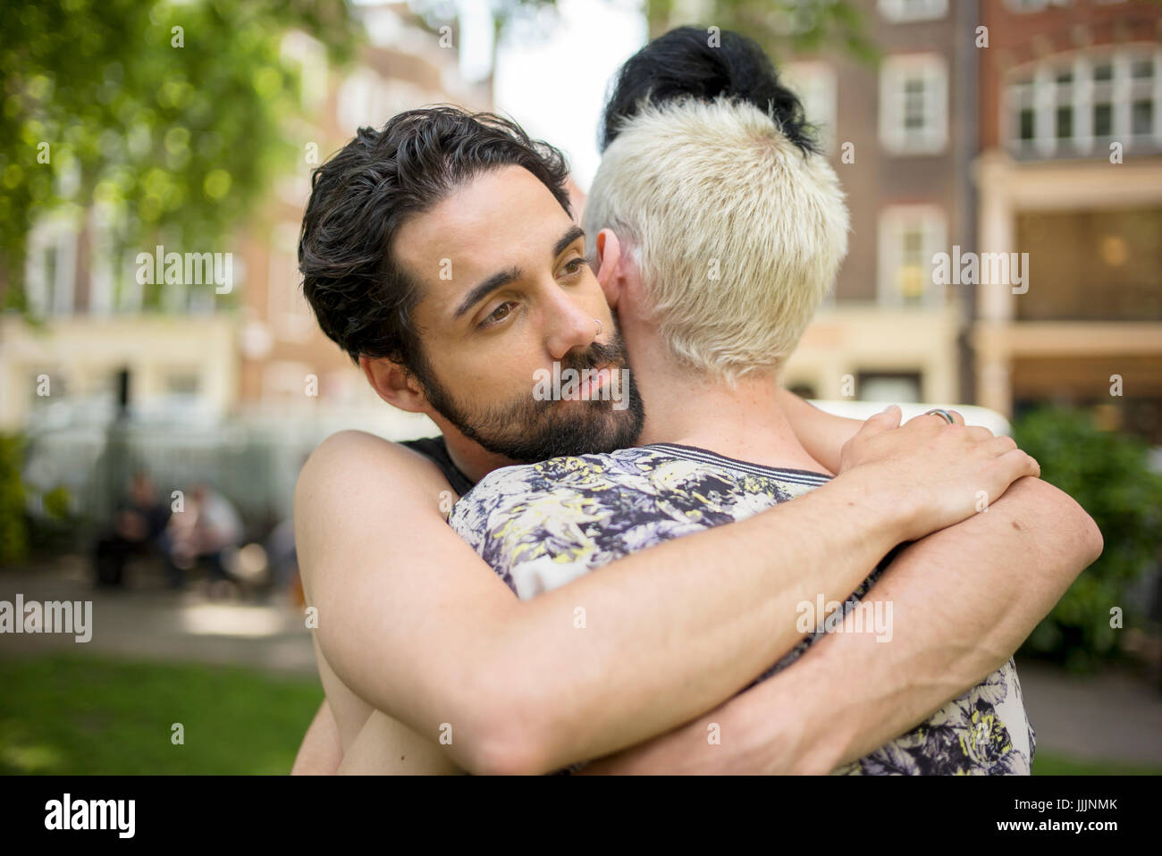 A gay couple hug each other. Stock Photo