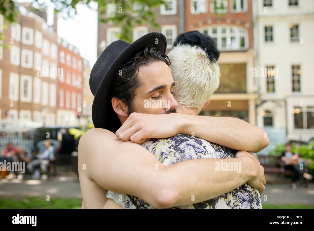 A gay couple hug each other. Stock Photo