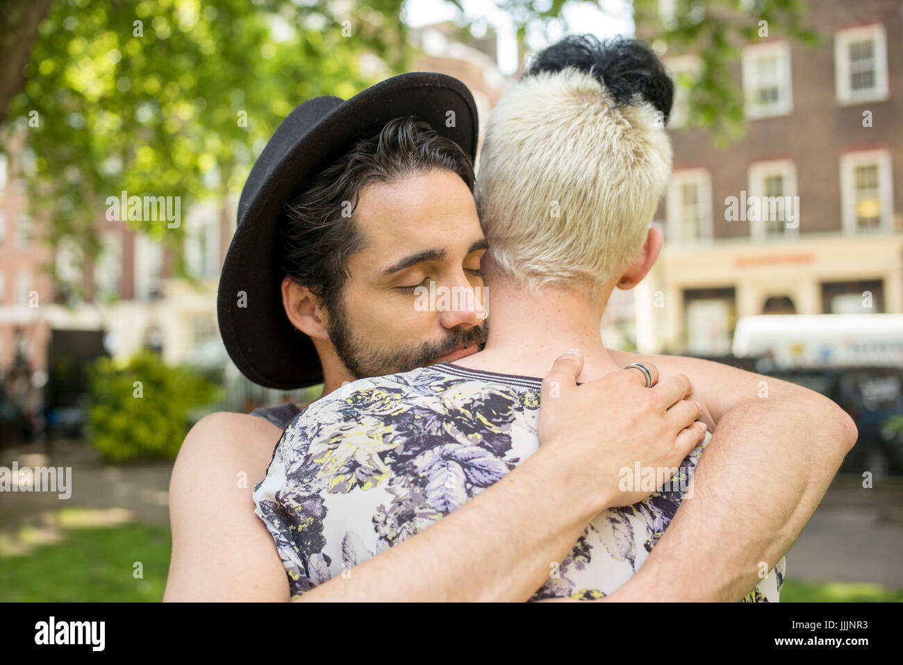 A gay couple hug each other. Stock Photo