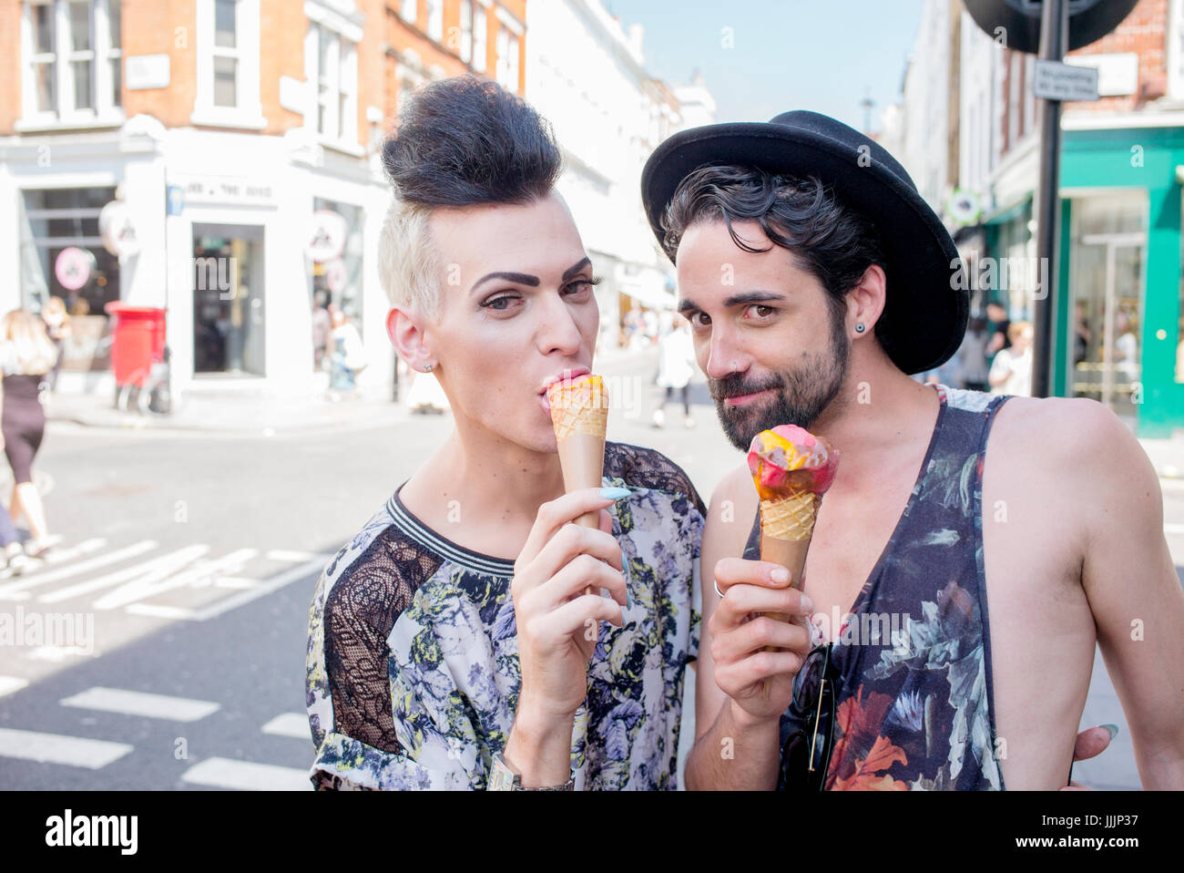 A gay couple enjoy an ice cream on a day out in London Stock Photo - Alamy