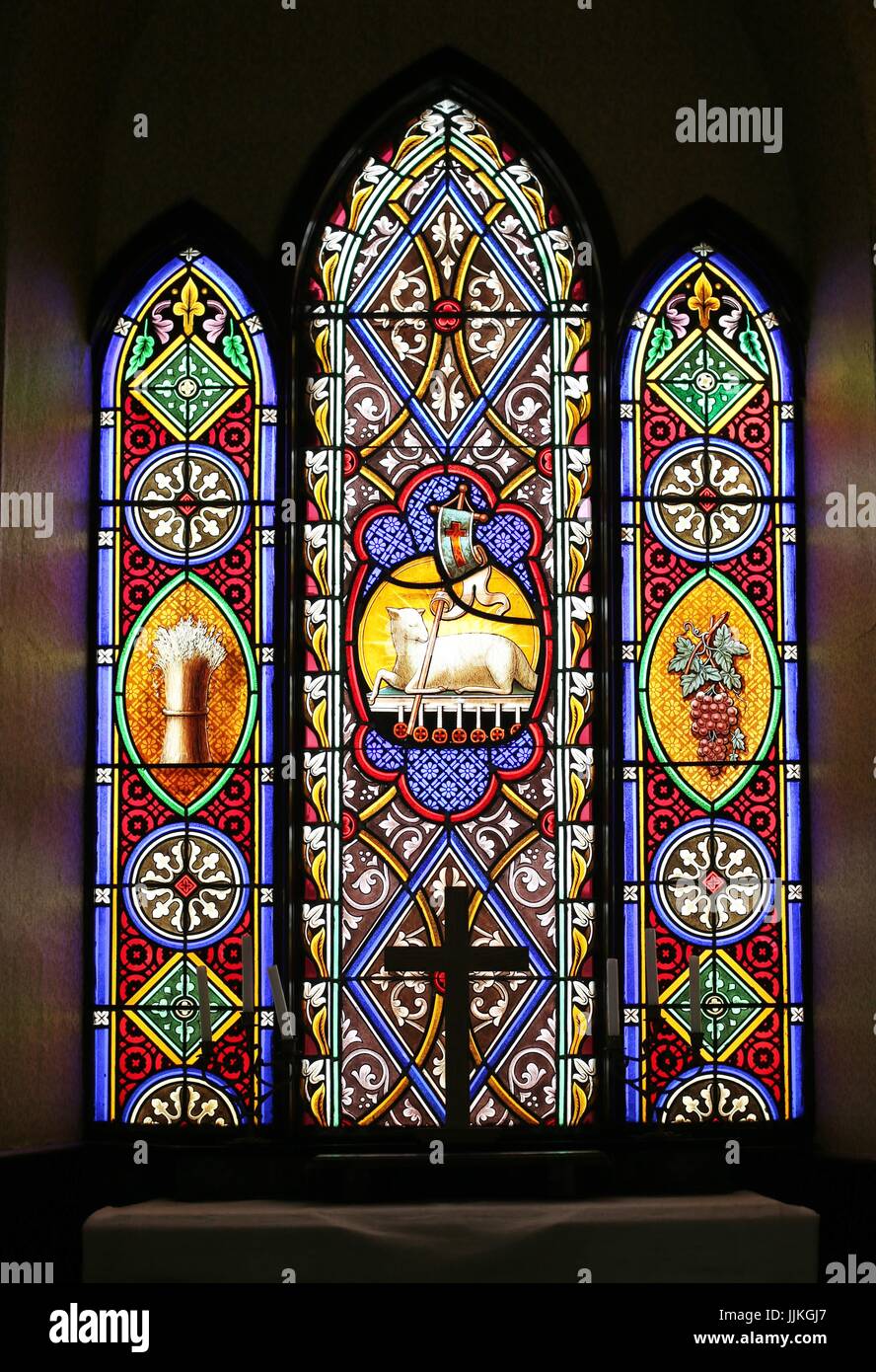 A stained glass window in an old church, on display at the Rice County