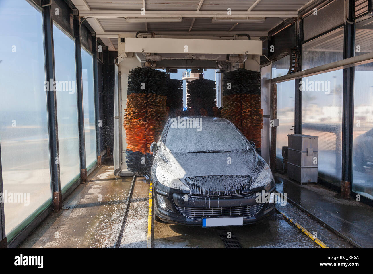 Car being washed in an automatic vehicle wash service station Stock Photo Alamy