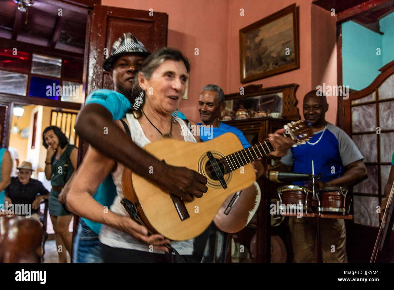 A SALSA BAND entertains a tourist in one of the many restaurant - TRINIDAD, CUBA Stock Photo