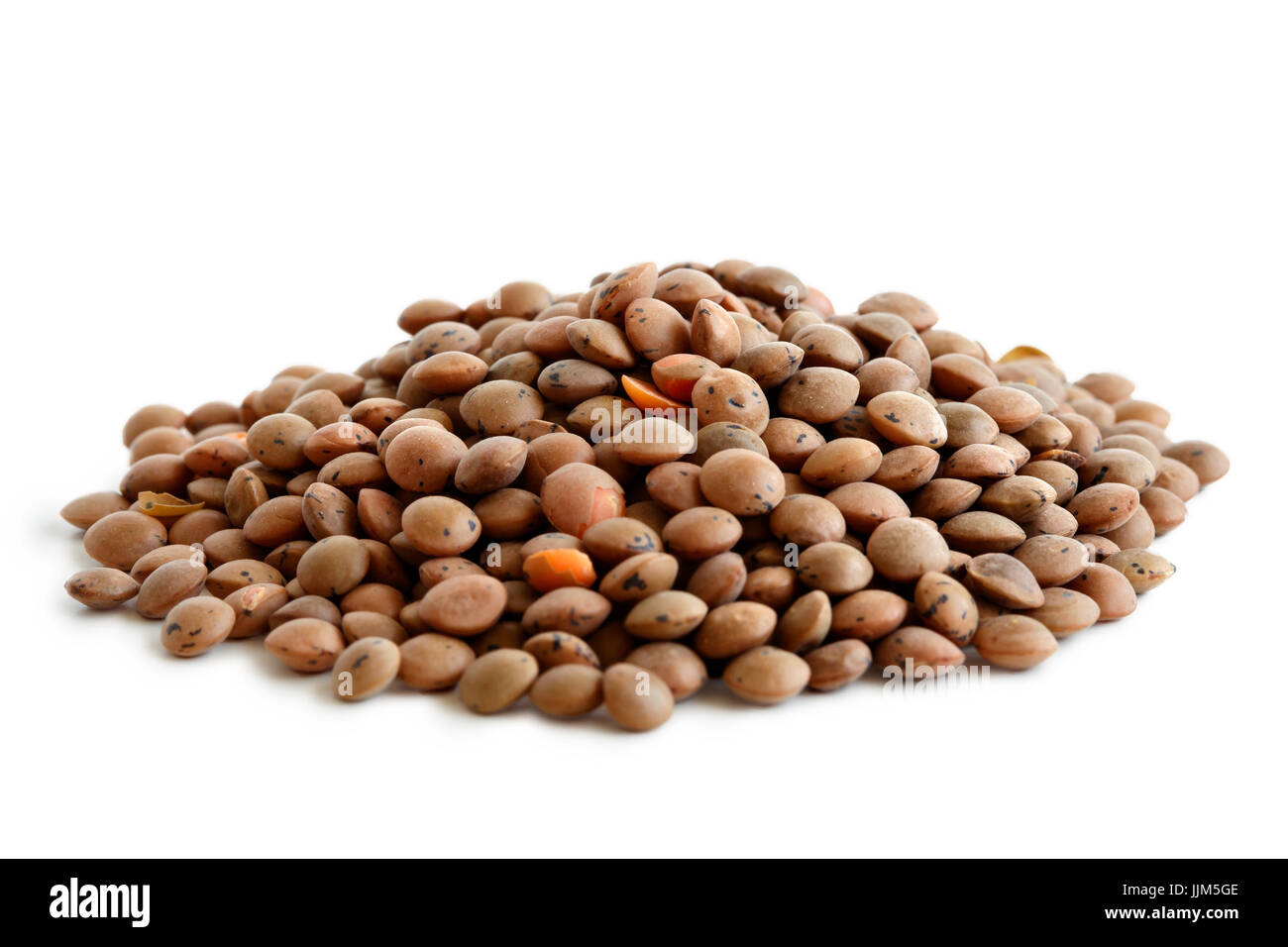 Heap of unpeeled red lentils isolated on white. Stock Photo