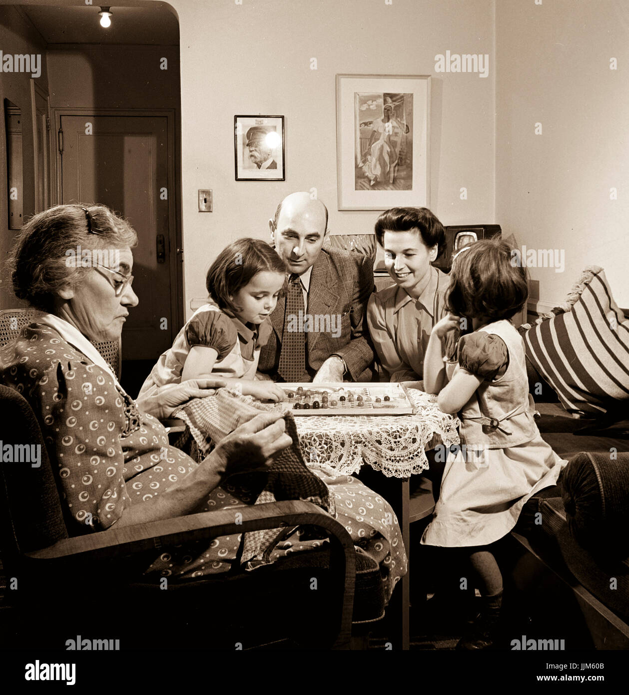 New York, New York. Dr. and Mrs. Winn [or Wynn], Janet and Marie, a Czech-American family, playing Chinese checkers while their grandmother knits.Collins, Marjory, 1912-1985, photographer.CREATED/PUBLISHED1942 Oct. Stock Photo