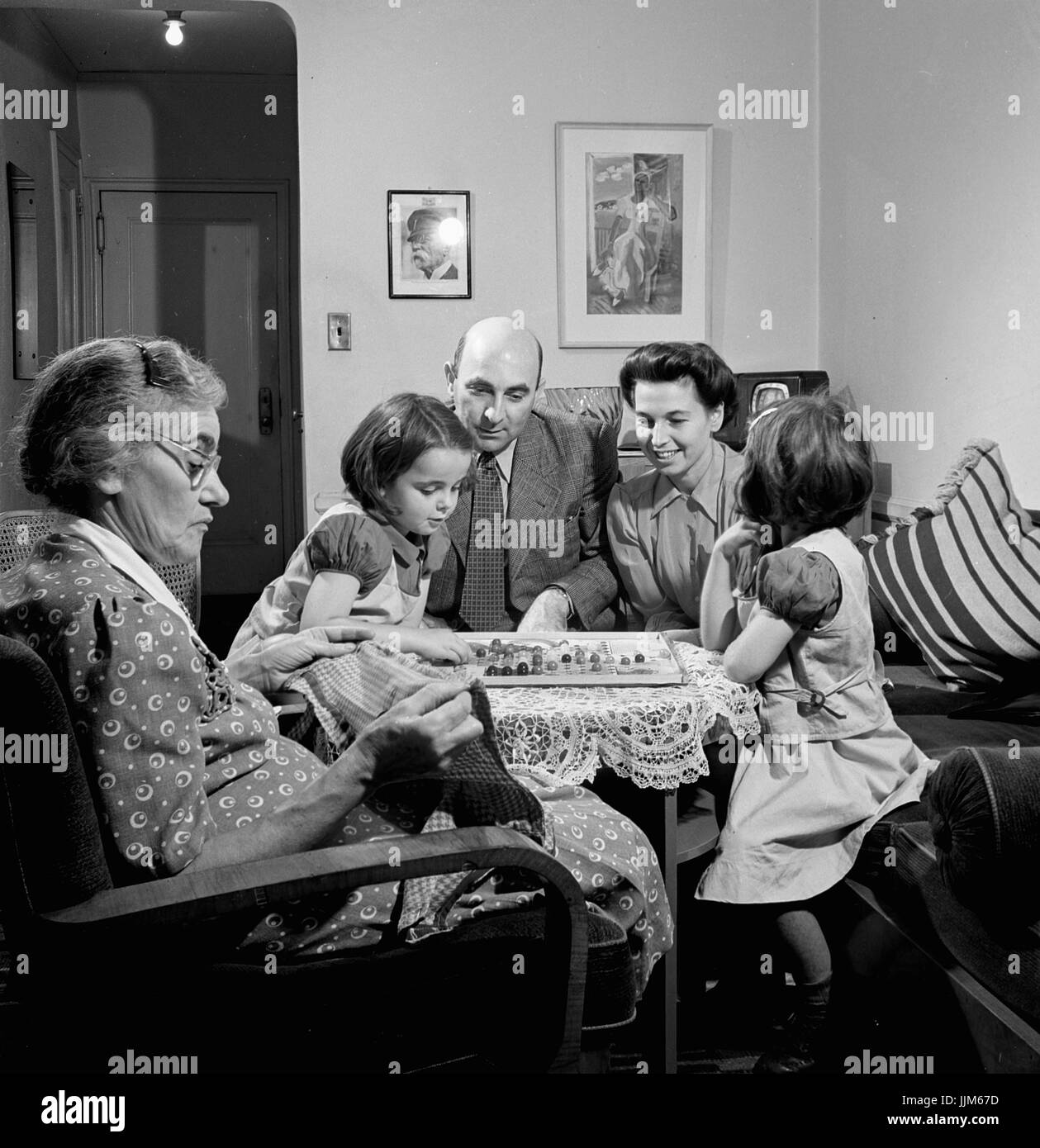 New York, New York. Dr. and Mrs. Winn [or Wynn], Janet and Marie, a Czech-American family, playing Chinese checkers while their grandmother knits.Collins, Marjory, 1912-1985, photographer.CREATED/PUBLISHED1942 Oct. Stock Photo