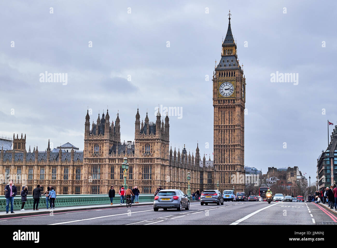 LONDON CITY - DECEMBER 24, 2016: People a and cars  on Westminster Bridge with Big Ben and the Parliament in the background Stock Photo