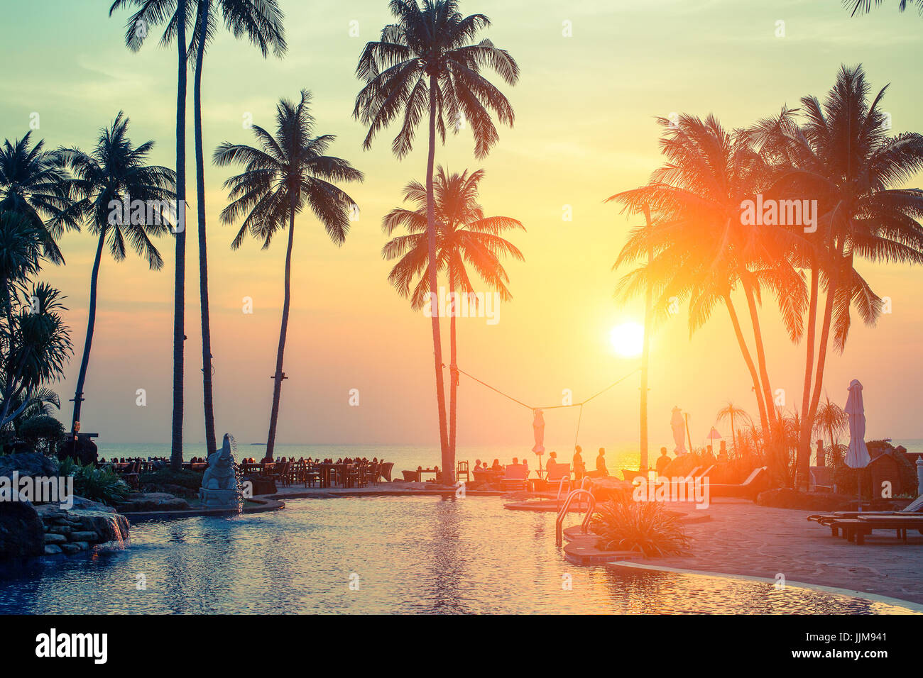 Palm trees on tropical beach during amazing sunset Stock Photo - Alamy