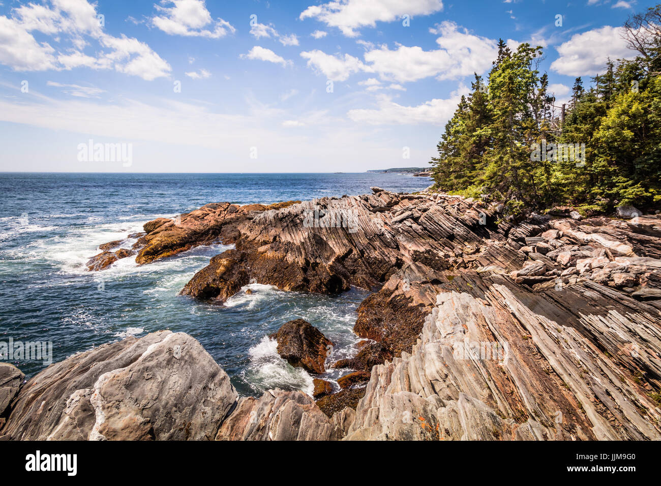 Scenic rocky shoreline in La Verna Preserve in Bristol, Maine, on a beautiful summer day Stock Photo