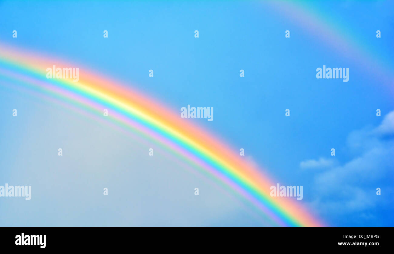 Double rainbow in sky with clouds. Nature background Stock Photo - Alamy