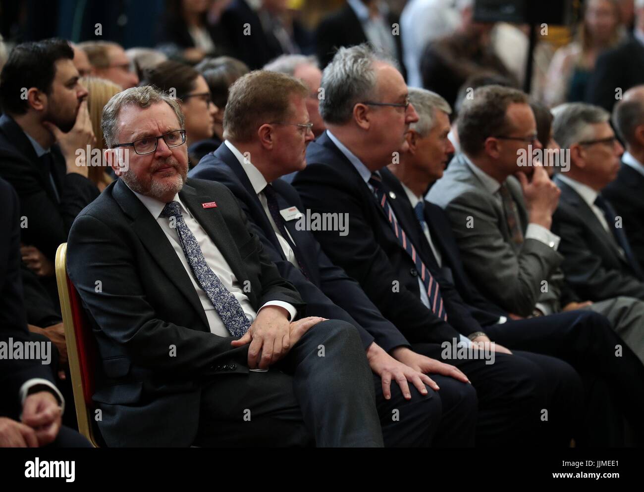 Secretary of State for Scotland Sir David Mundell (L) watches a monitor during a ceremony where cutting of steel on the first Type 26 frigate began at BAE System's Govan Shipyard near Glasgow. Stock Photo