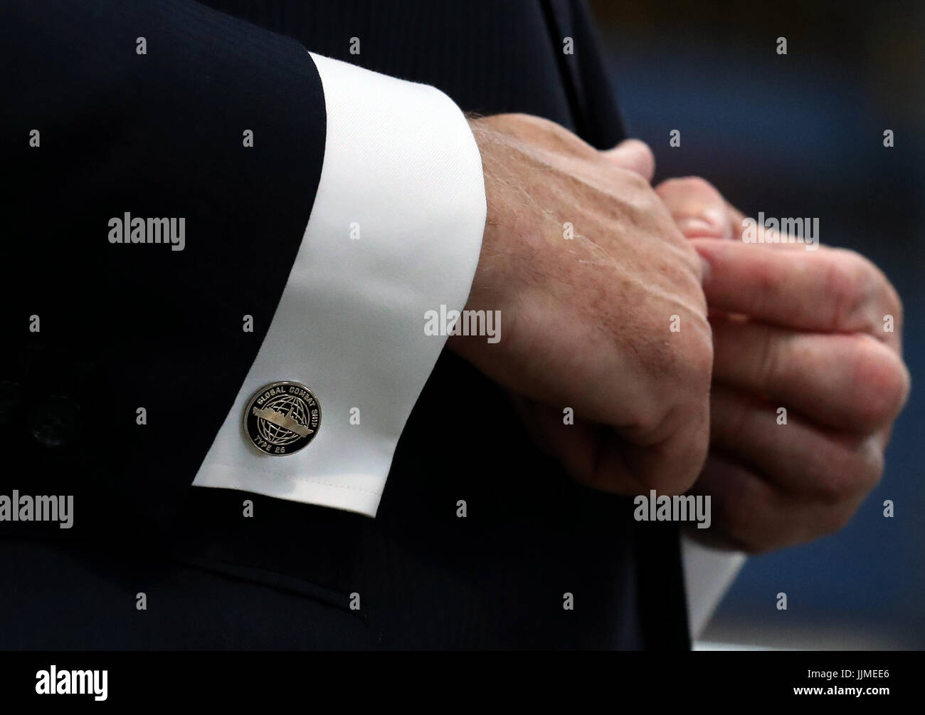 Defence Secretary Sir Michael Fallon shows off his cufflinks after cutting steel on the first Type 26 frigate at BAE System's Govan Shipyard near Glasgow. Stock Photo