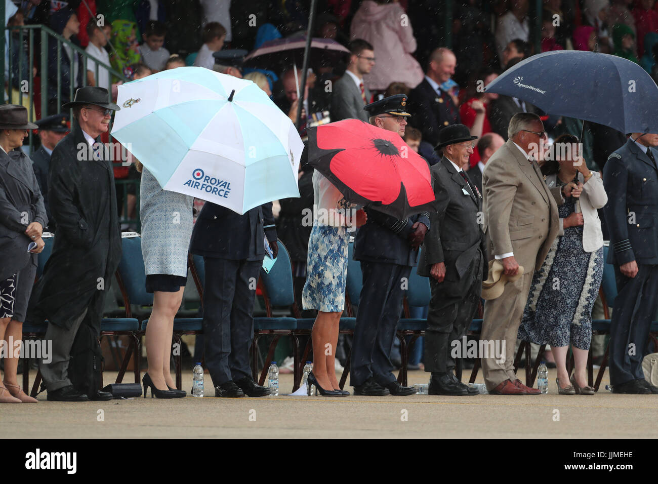 The crowd shelter from the rain as Prince Harry presents a new Colour at RAF Honington in Suffolk to the ground fighting force of the RAF in its 75th anniversary year. Stock Photo