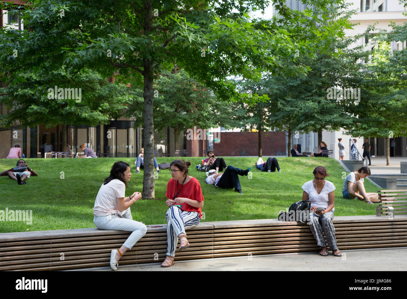Employees from offices spill out for lunch on grass at Battle Bridge