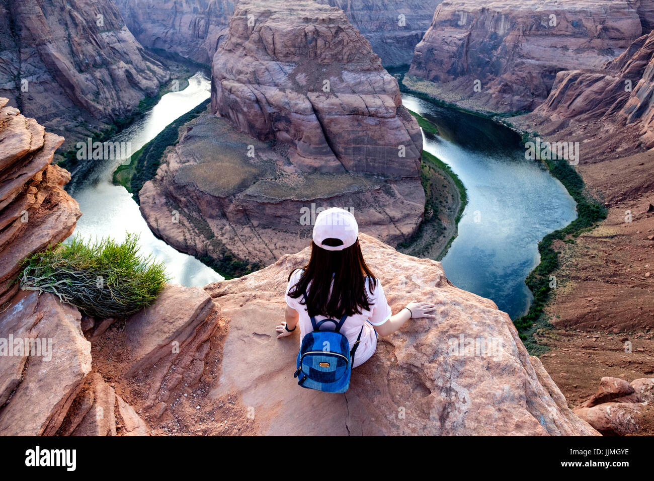 Sitting on the edge of a rock looking out into the Horseshoe bend scenic view Stock Photo