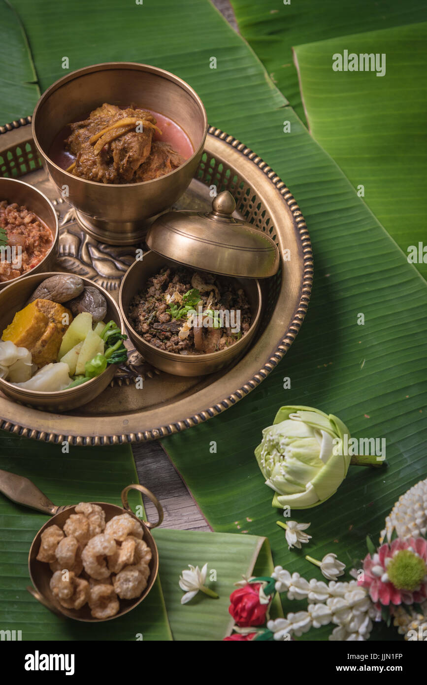Chiang Mai local food set on brass kitchenware with Banana leaves background Stock Photo