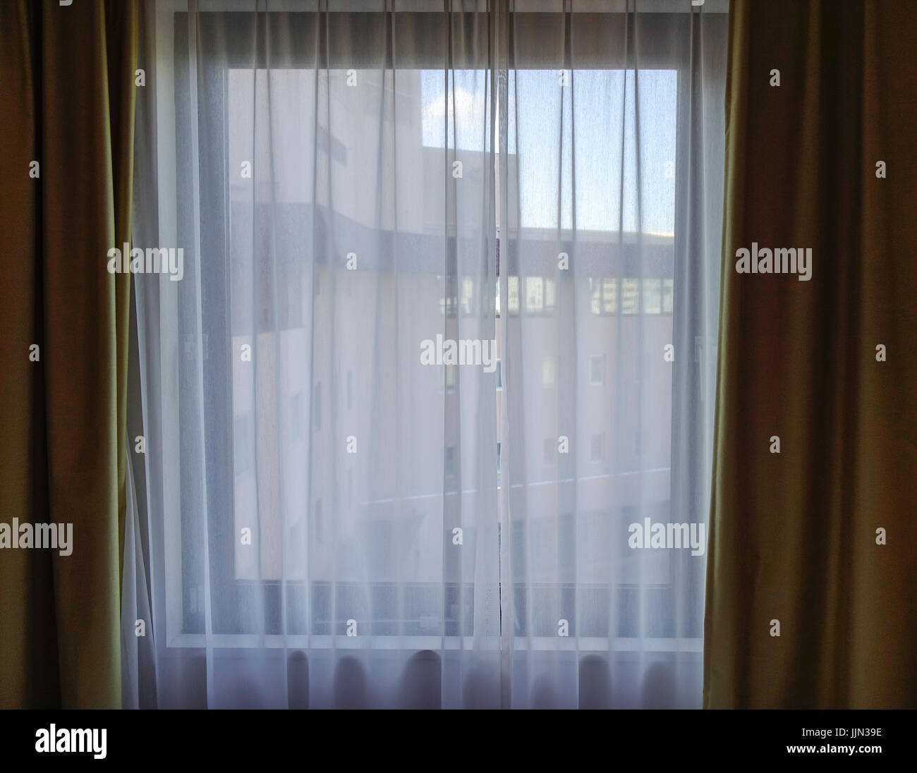 Sunrise Through Transparent Curtains Of A Window In Luxury Hotel