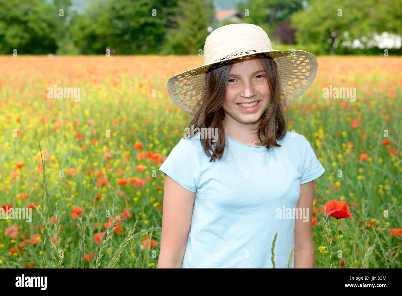 Young smiling teenager girl in poppy field Stock Photo - Alamy