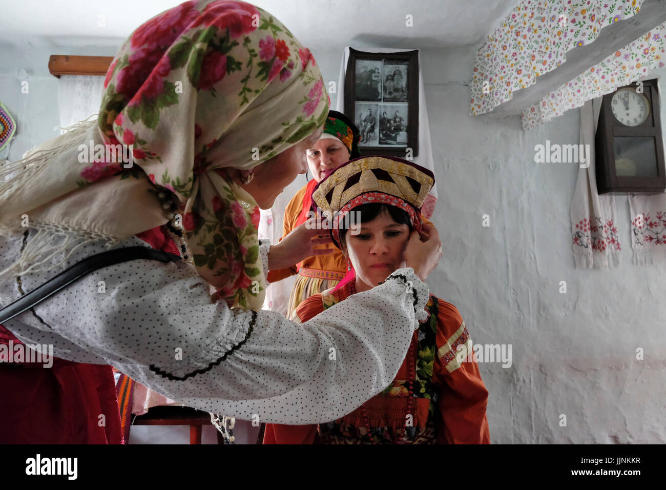 Russian Woman In Traditional Costume Puts The Kokoshnik Bridal Headdress To Accompany The