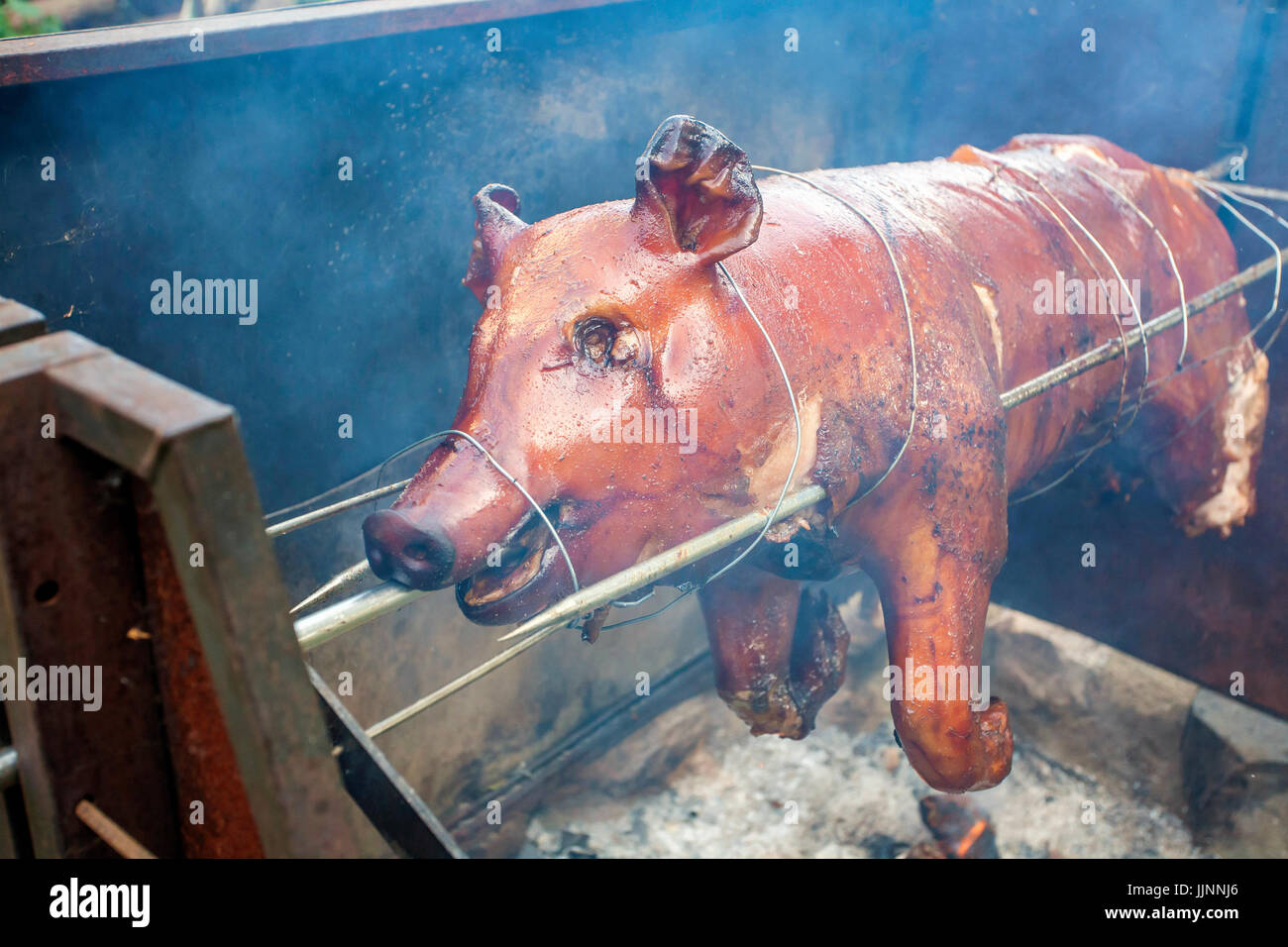Whole pig roasting at open fire Stock Photo Alamy