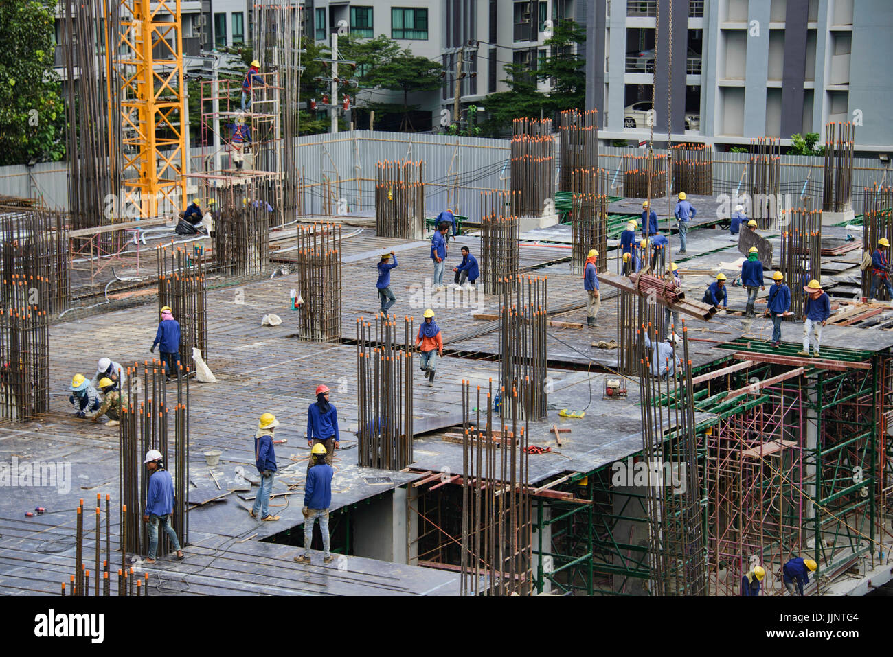 Construction workers on a high rise building in Bangkok, Thailand Stock Photo