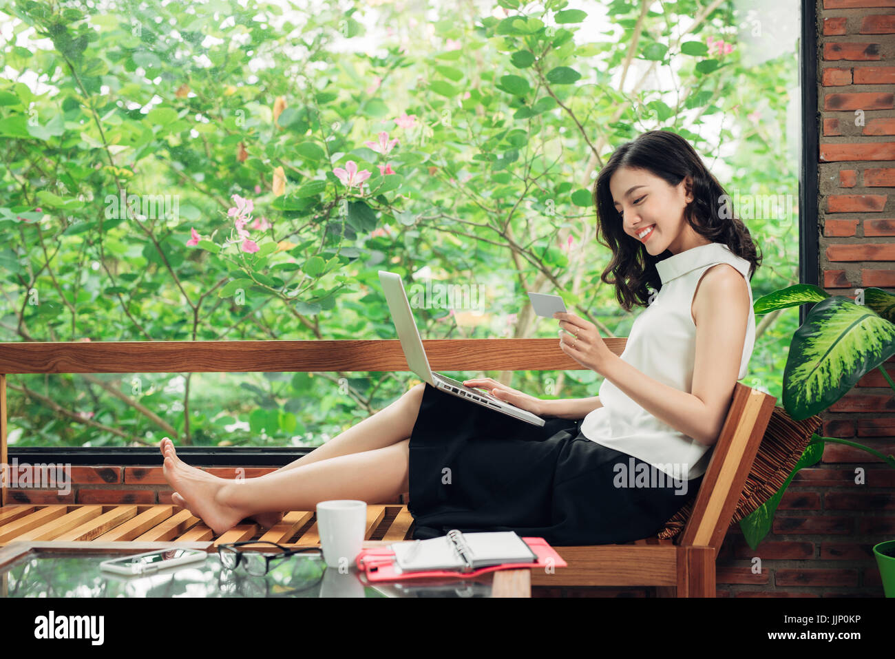 Confident young asian woman in smart casual wear using smartphone, Typing on phone. Stock Photo