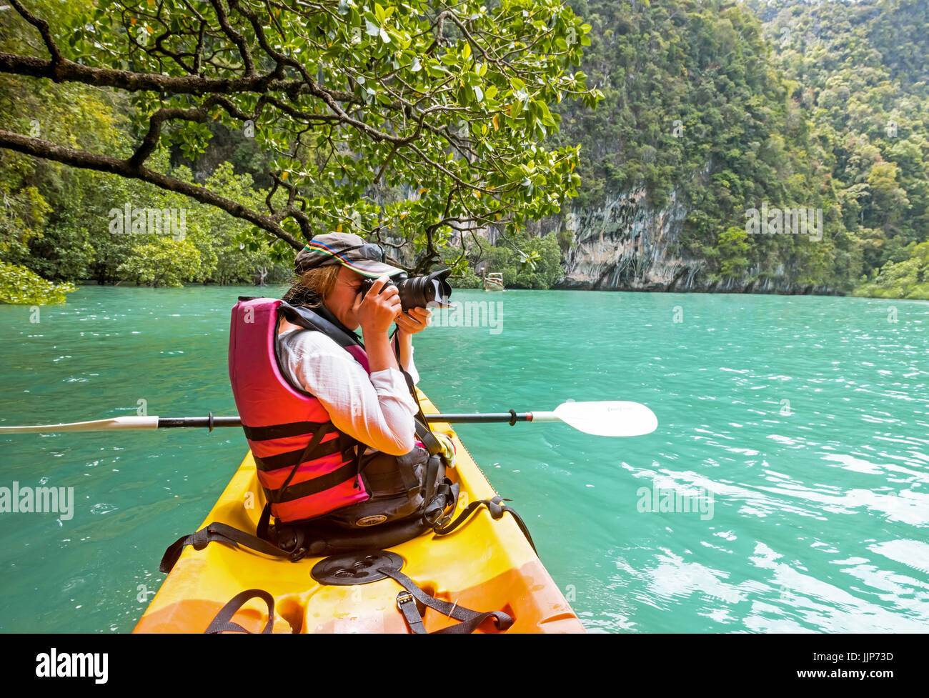 Woman on kayak in calm tropical lagoon Koh Hong Stock Photo