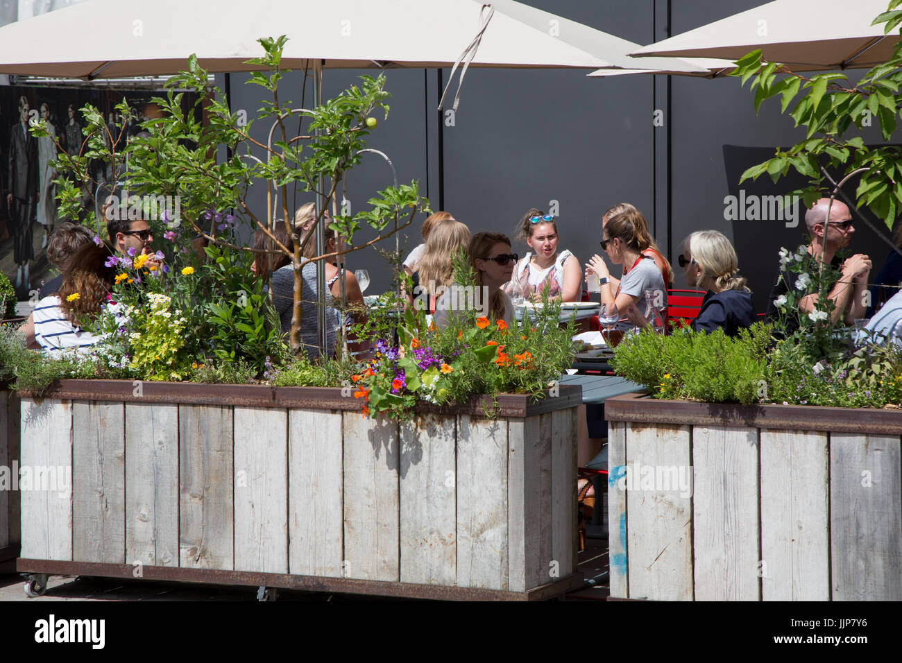 Grain Store, a restaurant in Granary Square King's Cross. Diners are eating al fresco in the garden outside Stock Photo