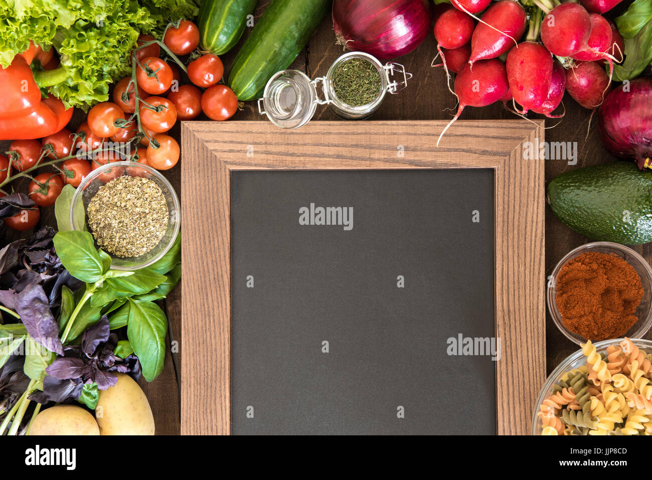 Blank chalkboard with set of ingredients and spices for cooking Italian