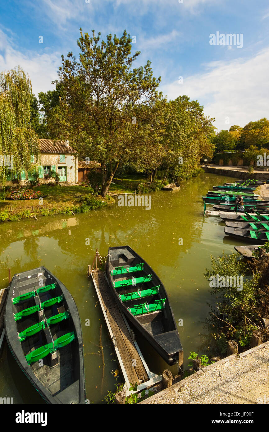 Paddle boats at the launch point for touring the Marais Poitevin 'Green Venice' wetlands. Arçais; Deux Sèvres; Nouvelle-Aquitaine; Fran Stock Photo