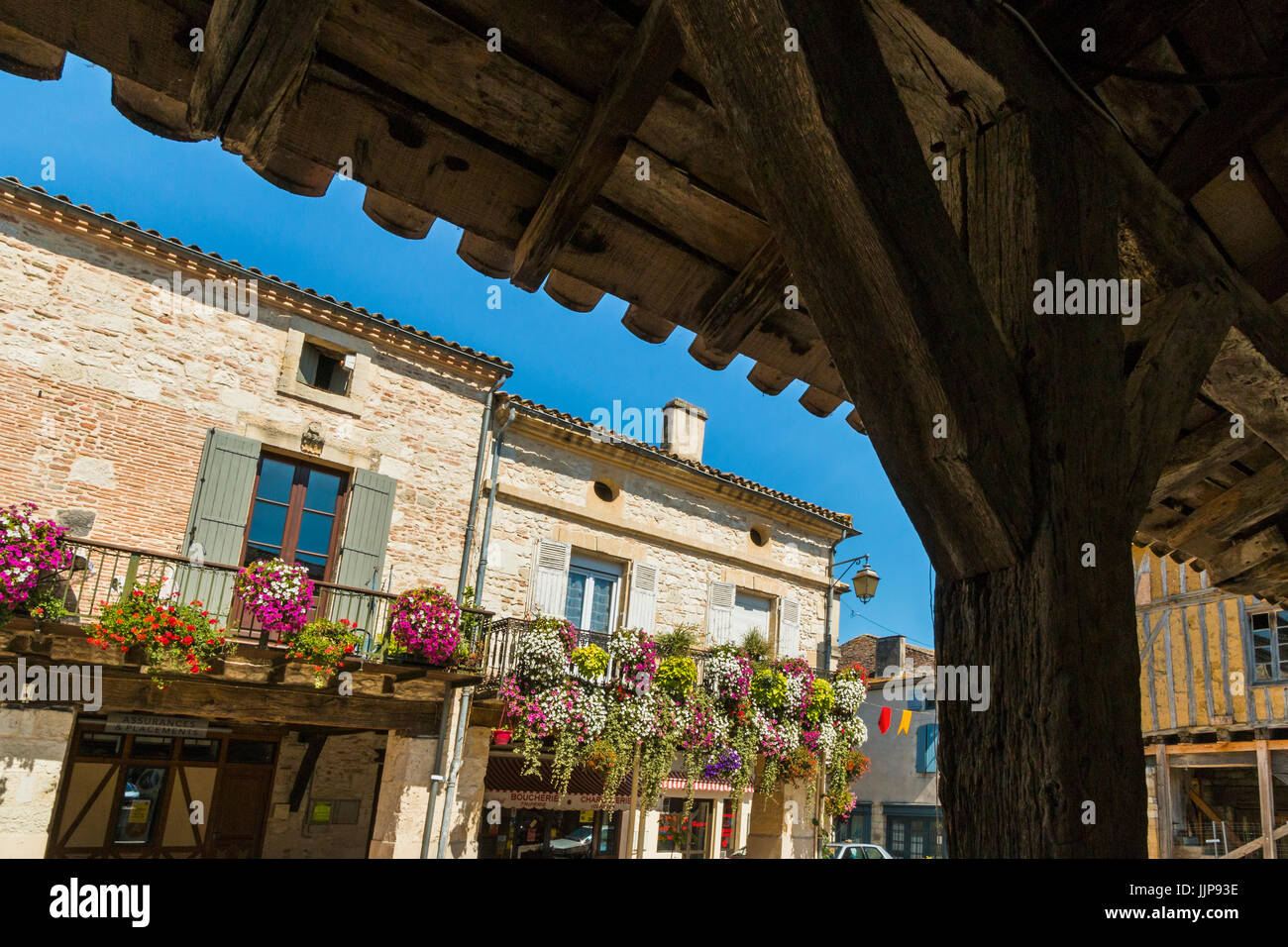 14thC market hall roof and flower displays on the Place de la Halle in this south western historic bastide town. Villereal; Lot-et-Garonne; France Stock Photo