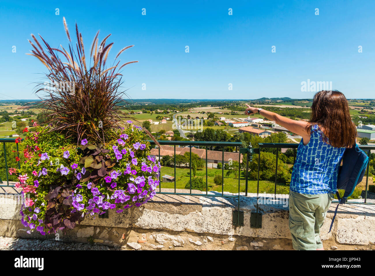 Sightseer & flower display on the east ramparts of this beautiful SW historic bastide town. Monflanquin; Lot-et-Garonne; France Stock Photo