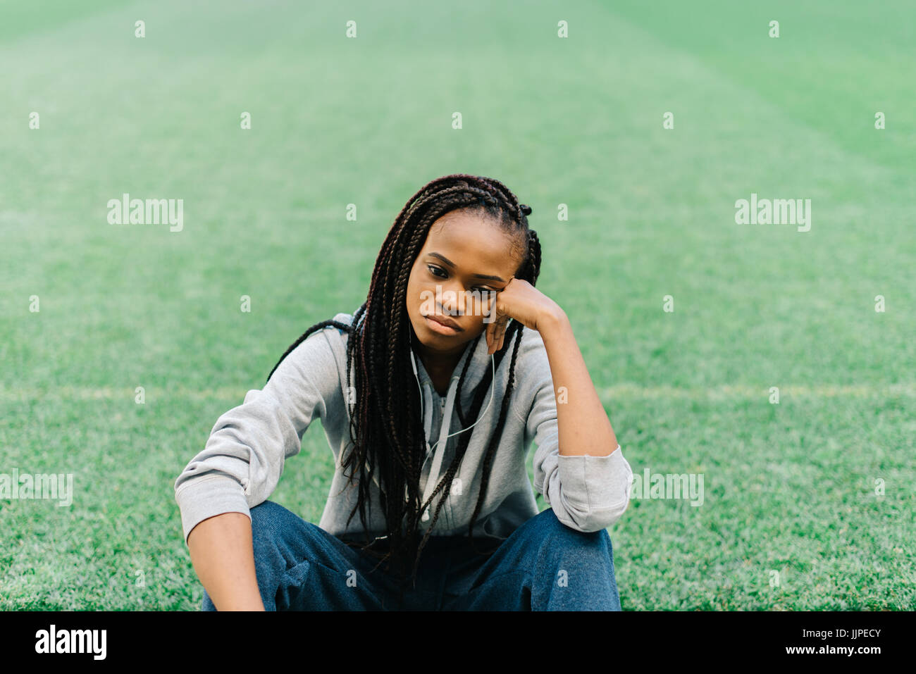 Sad girl sitting grass hi-res stock photography and images - Alamy