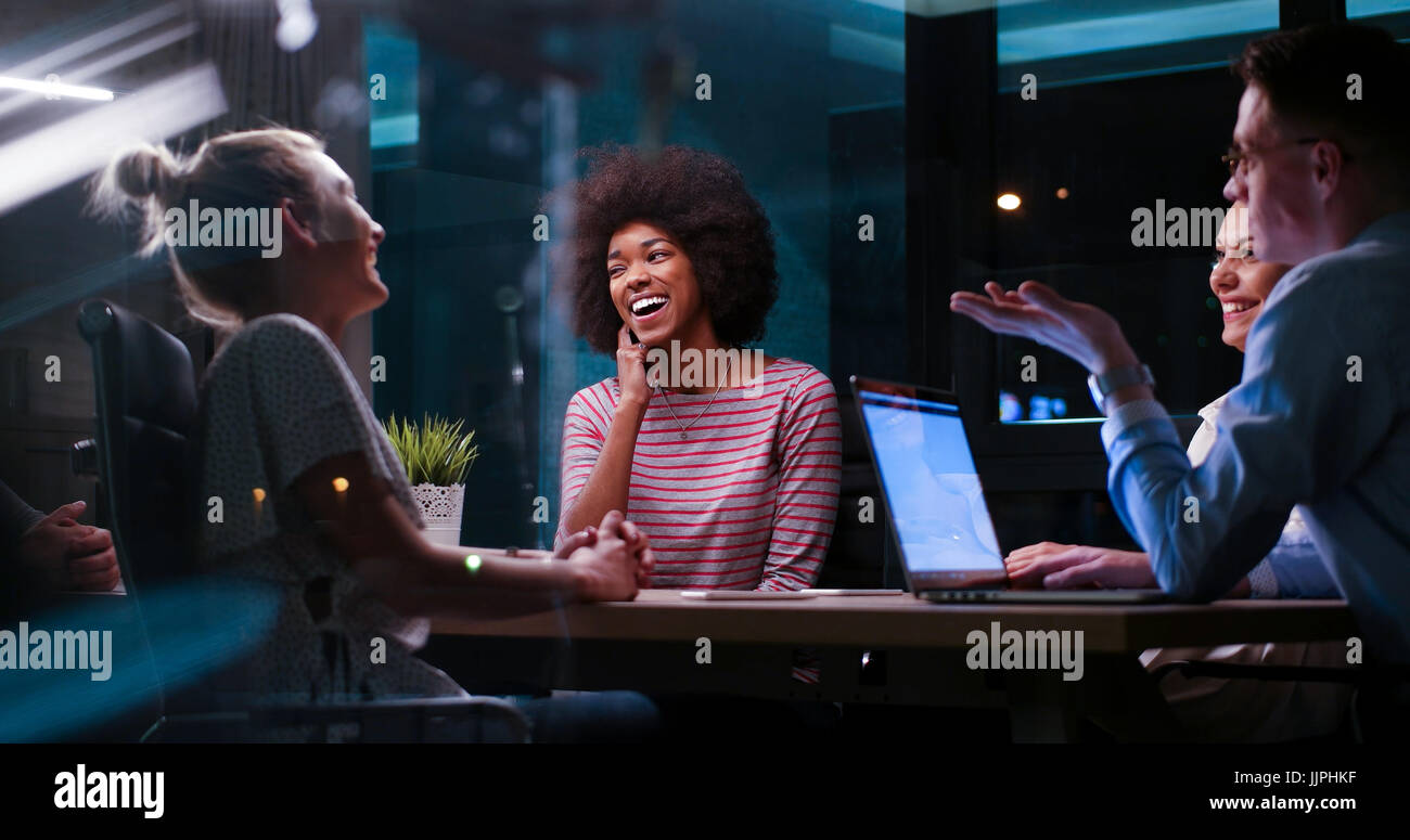 Multiethnic startup business team on meeting in modern night office ...