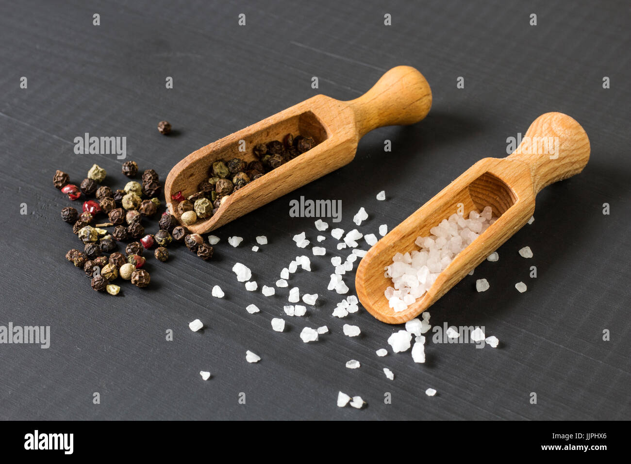 salt and pepper on wooden spoons Stock Photo