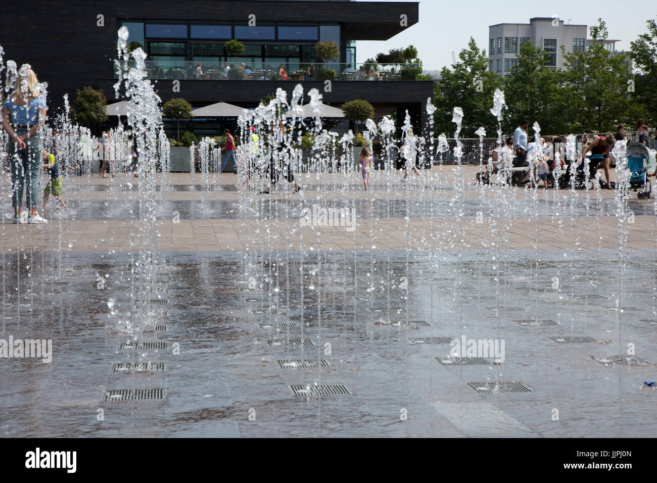 Fountains in Granary Square, London attract youngsters to cool down in