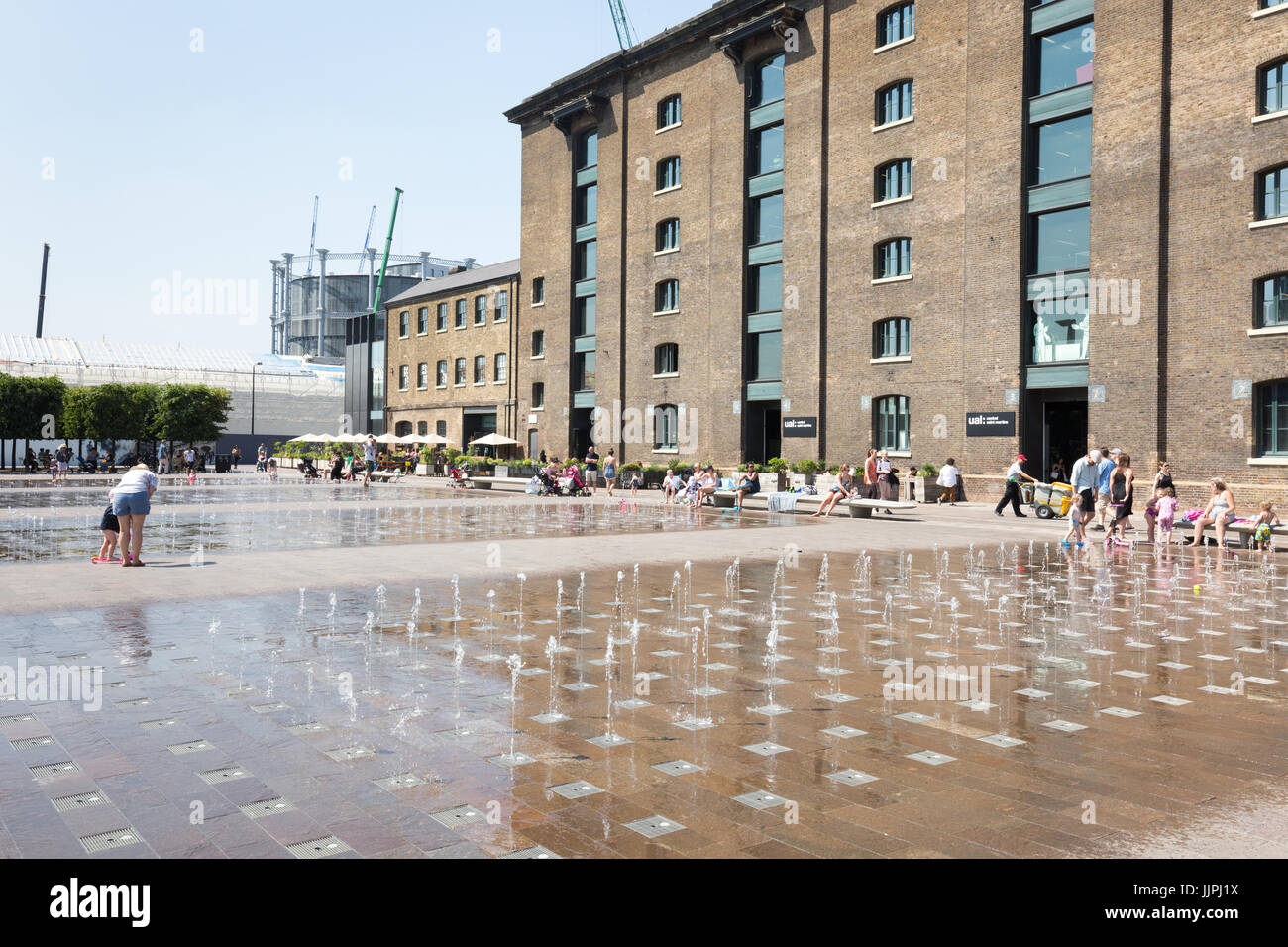 Fountains in Granary Square, London attract youngsters to cool down in