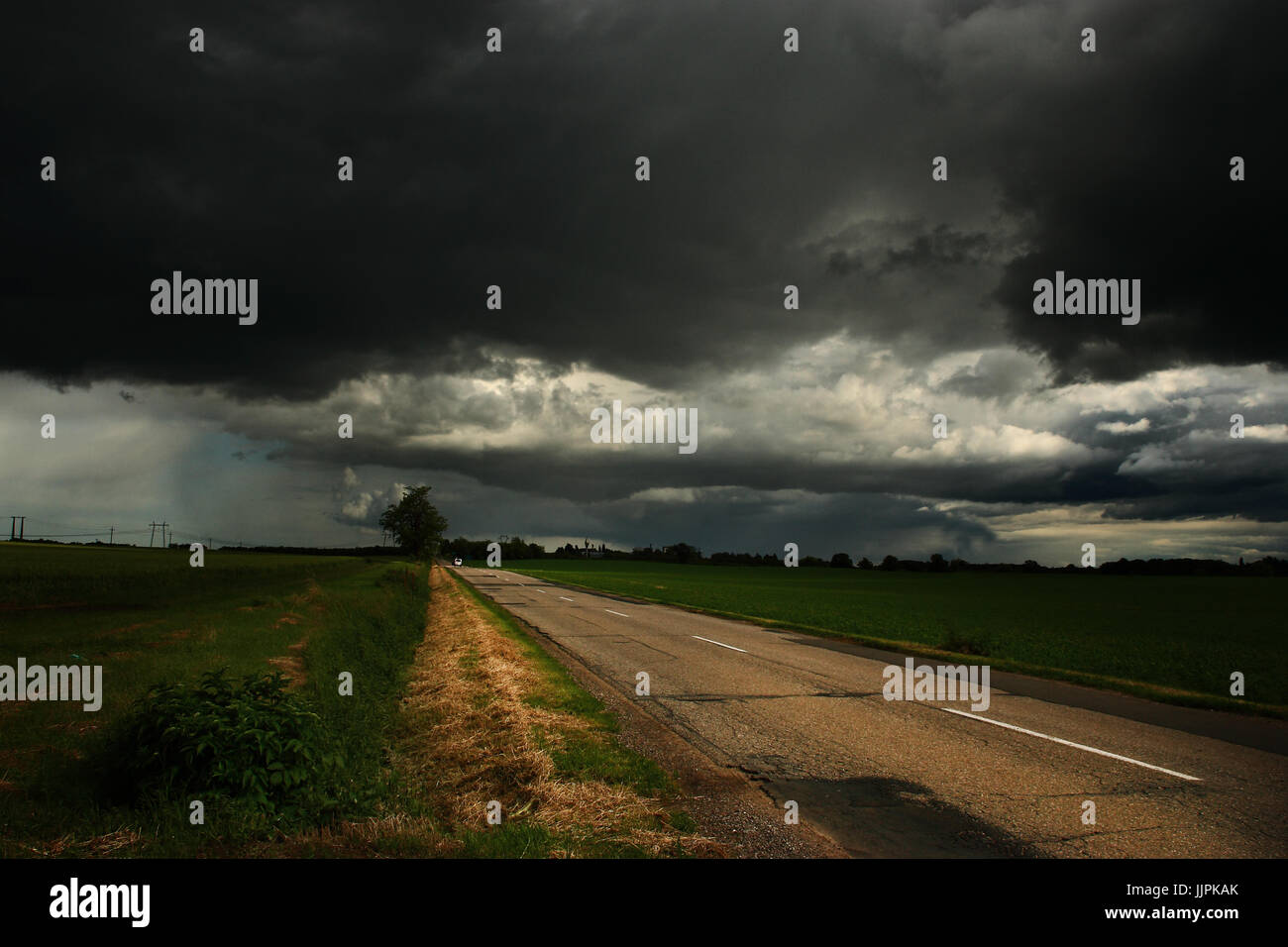 Stormy clouds over asphalt road Stock Photo - Alamy