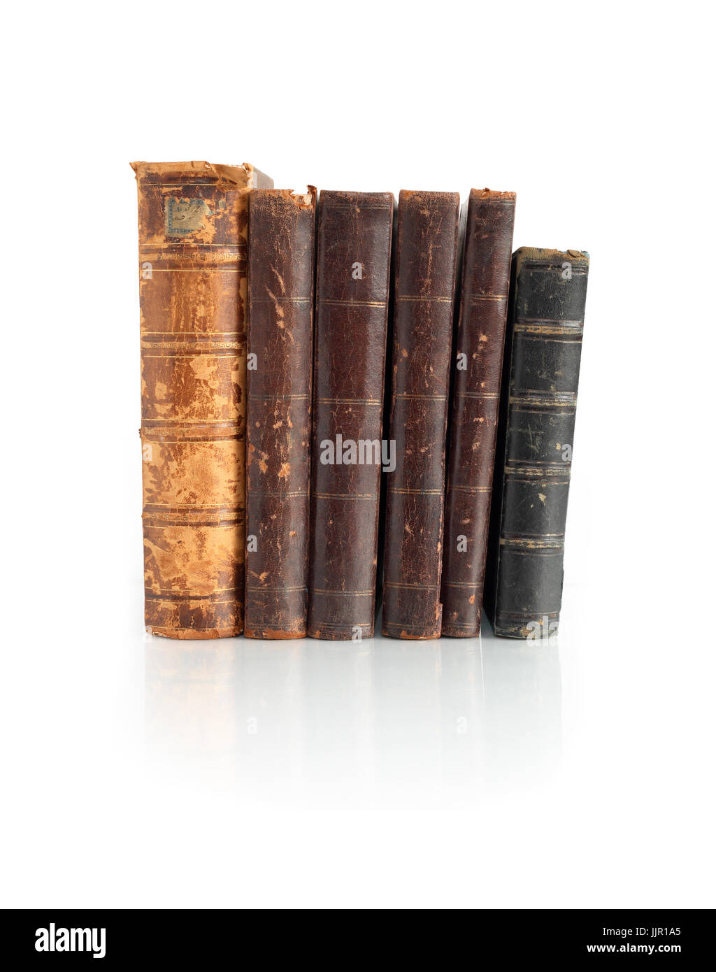 Few old books standing in a row on white background. Clipping path is included Stock Photo